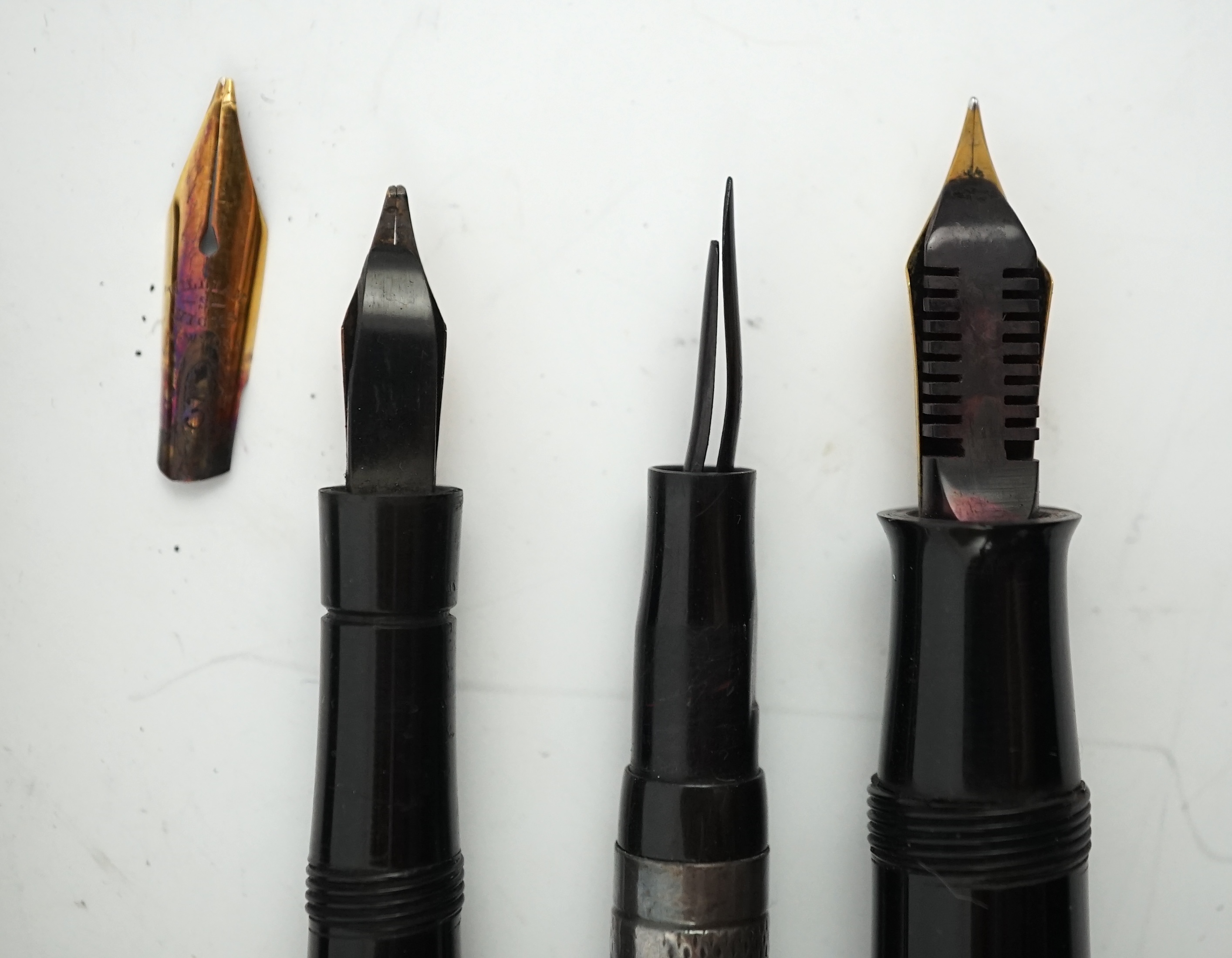 Four sundry fountain pens to include a silver hallmarked Eyedropper